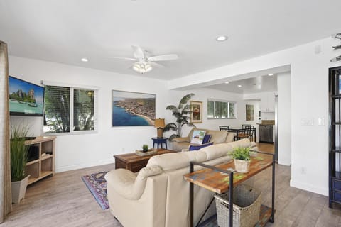 View of main living spaces from the front entry. Open floor plan between living, kitchen and dining areas.
                