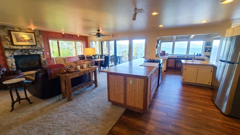 Kitchen, living room and dining all have lake views and open concept design