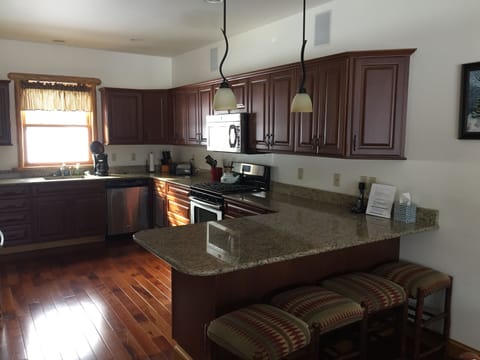 Full kitchen with refridgerator, microwave, dishwasher, sink, freezer, and stove