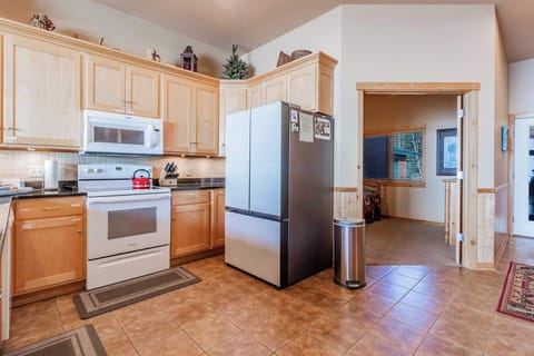State-of-the-art refrigerator in kitchen and access to main floor bedroom