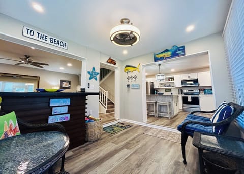 Sunroom at entry, off kitchen and living room. Tommy Bahama Bar and seating. 