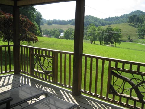 Front covered porch looking across pasture.