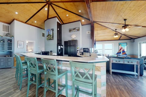 There is 8 seats around the large kitchen ledge