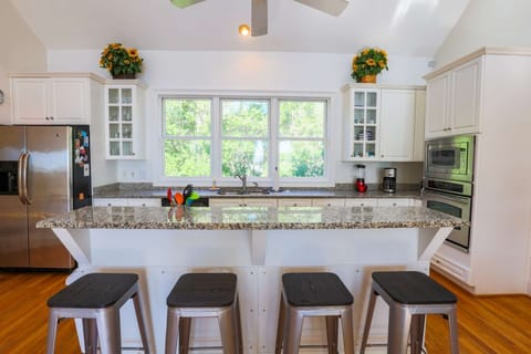 There are four stools at the kitchen island counter.