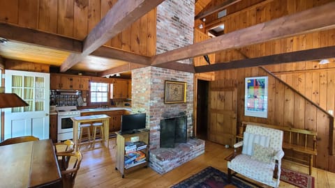 Main living area with knotty pine and exposed beams