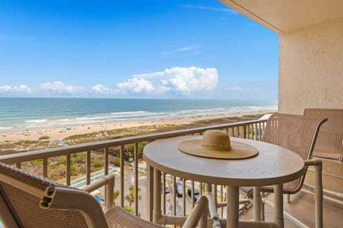 Private balcony with seating and ocean views, ideal for unwinding with a drink.