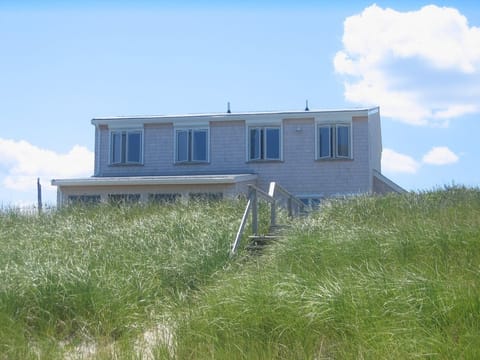 Beach House with sun reflected in the beach grass in July