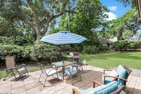 Private patio with outdoor furniture and a gas grill.