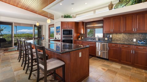Gourmet kitchen with high end appliances , stocked with spices & oils