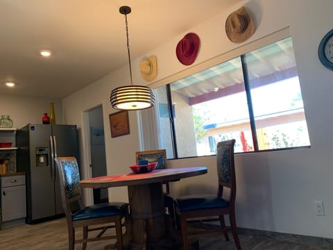 Dining area next to kitchen, laundry room is door next to refrigerator.