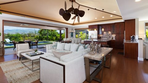 Large open concept living with vaulted grass cloth ceilings