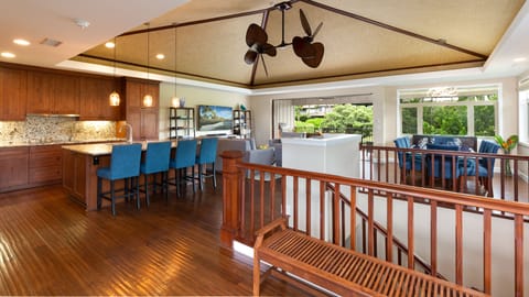 Spacious open concept living and dining area with woven grasscloth ceilings