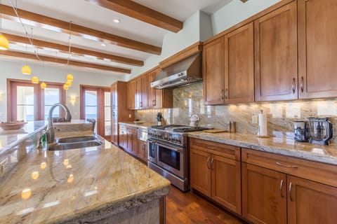 This kitchen is enormous! It is fully stocked with all cooking supplies!