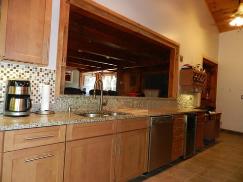 Timber Chalet Kitchen with beverage fridge, dishwasher and breakfast bar.
