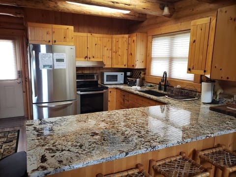 Large peninsula kitchen counter top for plenty of meal prep and serving space.