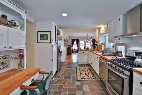 Long view of the kitchen with desk on the left
