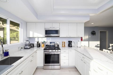 The kitchen is well stocked with cookware, utensils, silverware, and glassware. 