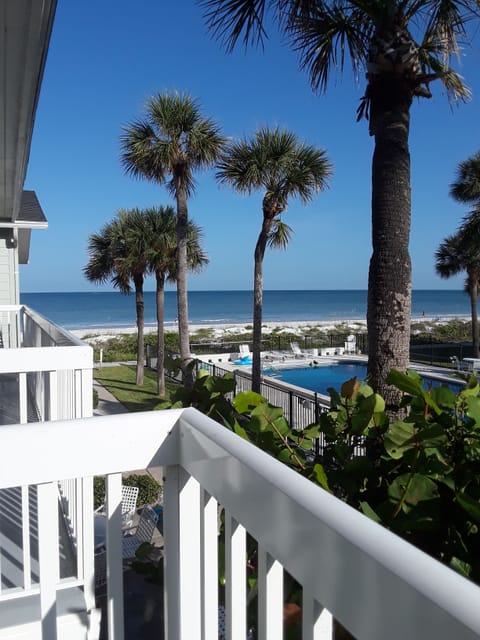 Gulf view from master balcony with pool, palms, and beach