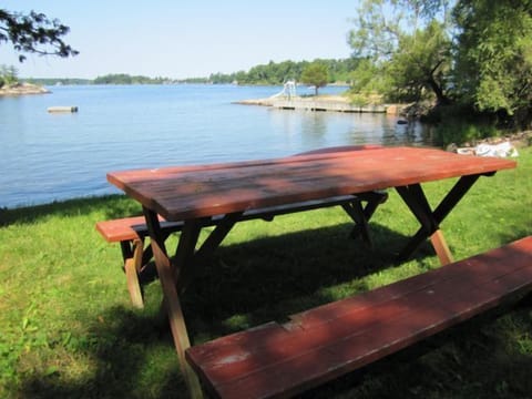 Picnic play area with access to large field, swing set, and water sports