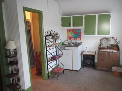 Another view of studio bedroom on second floor. Entrance to full bath on left