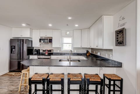 Wide Kitchen bar seats up to 7 and still lots of space for food prep