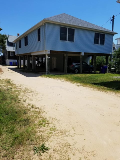 Outside of cottage with parking underneath.