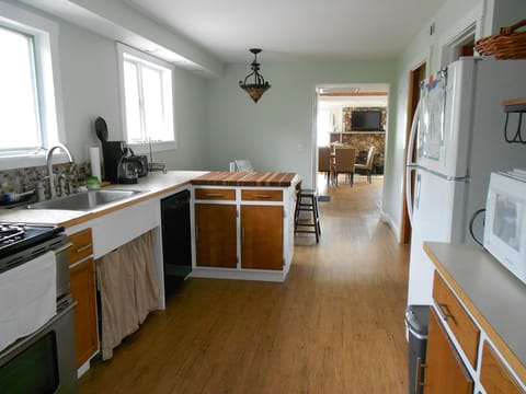 Kitchen with view into dining and living room beyond.