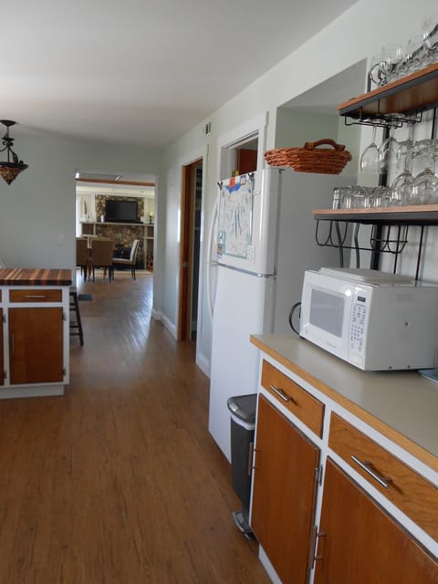 Kitchen with refrigerator/freezer and microwave.