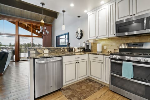 Kitchen opens up to living and dining area with picturesque view
