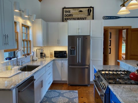 The pretty white kitchen with updated appliances, cabinets and granite counters!