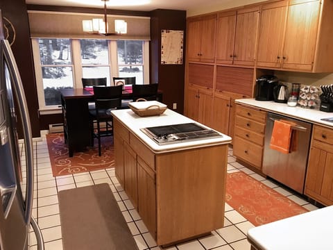 Kitchen with a counter height eat-in breakfast table and large windows