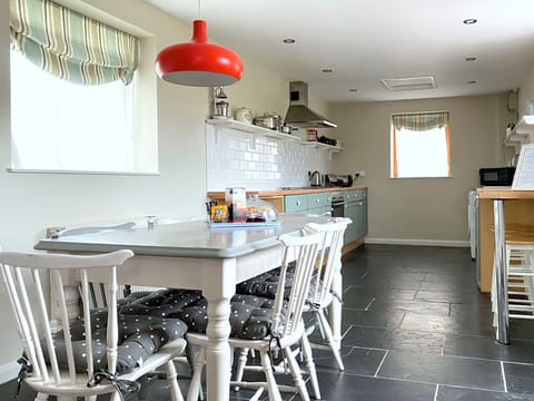 Spacious well-equipped kitchen and dining area, with door to south facing patio.