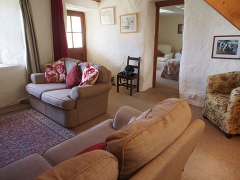 Sitting room with wood burning fire in large inglenook