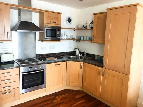 Open plan lounge, kitchen dining, with patio doors/balcony and sea views