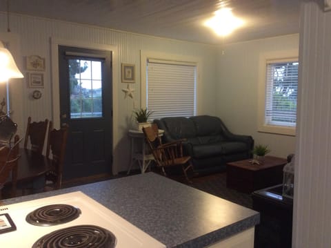 Kitchen looking into Living Area and Dining Area with front door in the middle.
