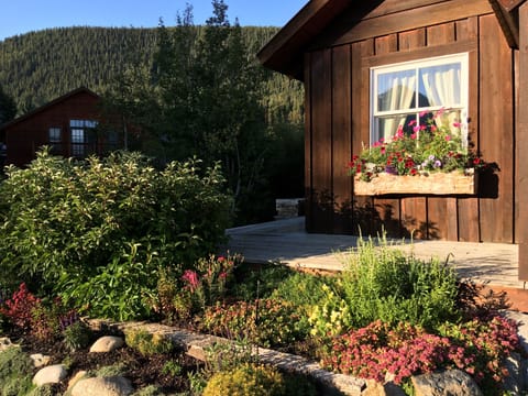 A beautiful garden and flower boxes surround the deck in summer.