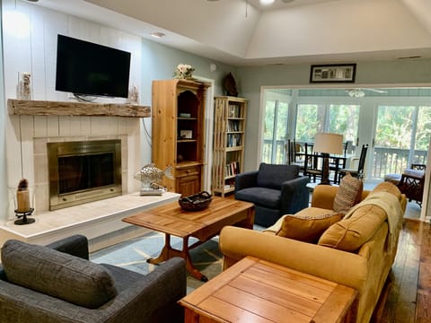 Bright living room and sunroom create a great main living space in this cottage.