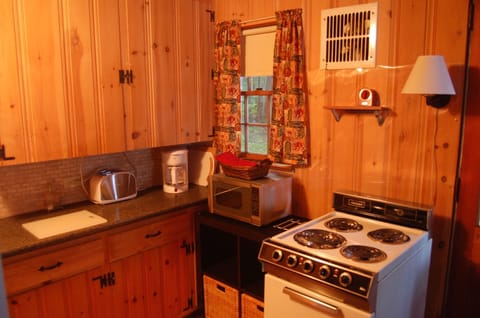 Kitchen with new stove and 3/4 refrigerator.