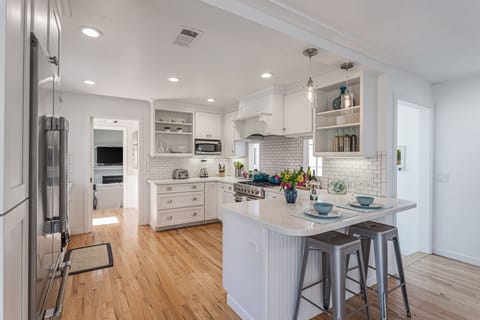 Beautifully designed open kitchen well stocked with cookware