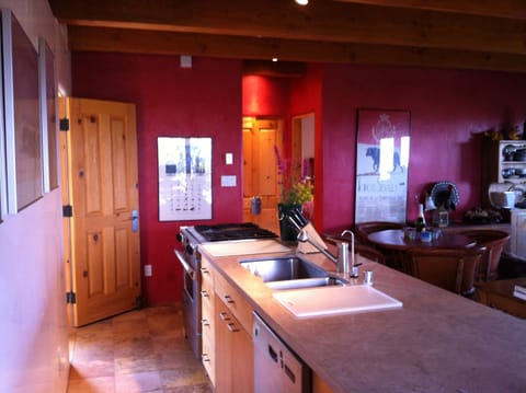 kitchen island with range, sink, dishwasher, under-the-counter fridge/freezer