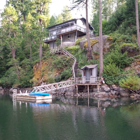 A view of the cottage and private dock from the water