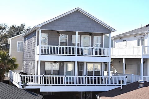 Front of house w/ huge 1st level deck and 2nd level balcony