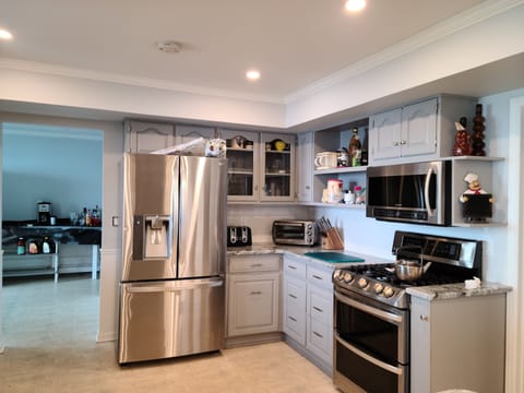 Kitchen, equipped with stainless steel appliances and 2 refrigerators