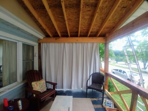 Seating on the deck includes wrought iron table and wicker couch set.