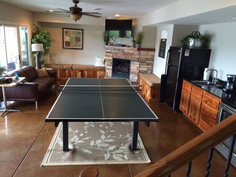 Second kitchen with pingpong table and tv in the downstair's living area