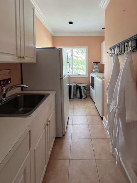 Washer and Dryer room equipped with additional refrigerator and freezer and sink