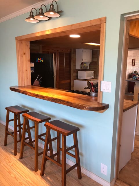 New pecan slab bar between kitchen and back room 