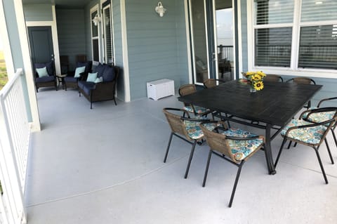 Dining for 8 with views of the bay, beach and fishing pond.