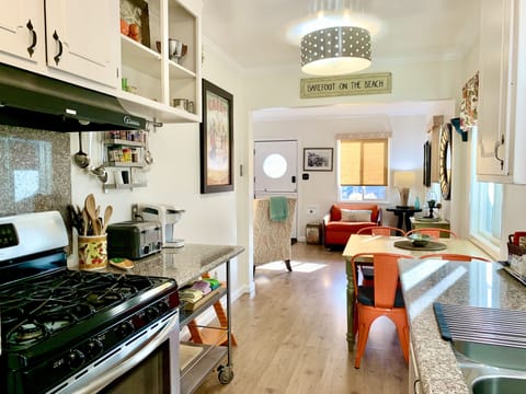 View from kitchen into living room.   Lots of light with many windows. 
