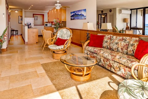 Living room looking into the fully stocked kitchen.